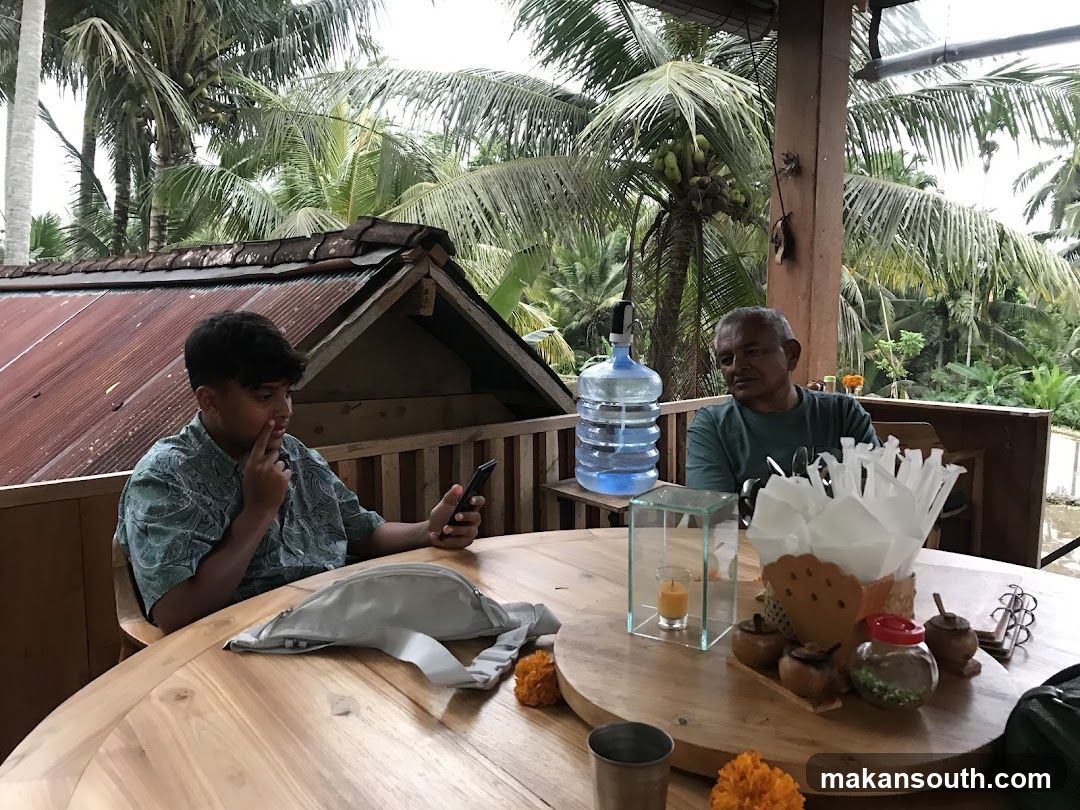 Two men sitting at a table outdoors