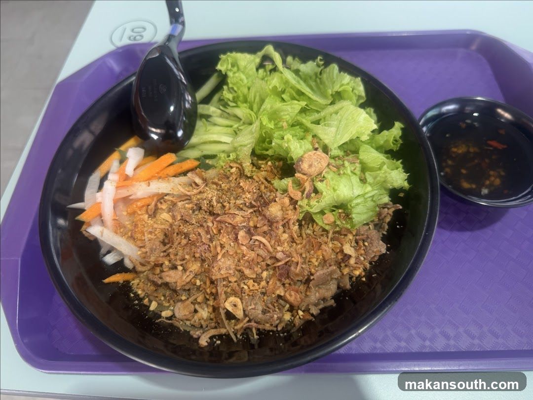 Bowl of food with lettuce, meat, and vegetables