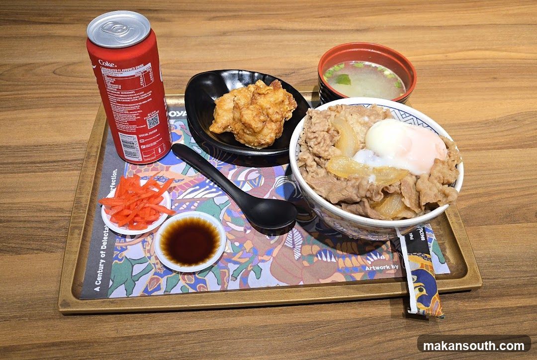 Beef bowl meal with fried chicken and soda