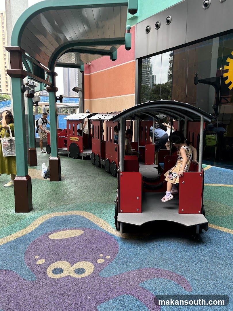 Children on a toy train ride