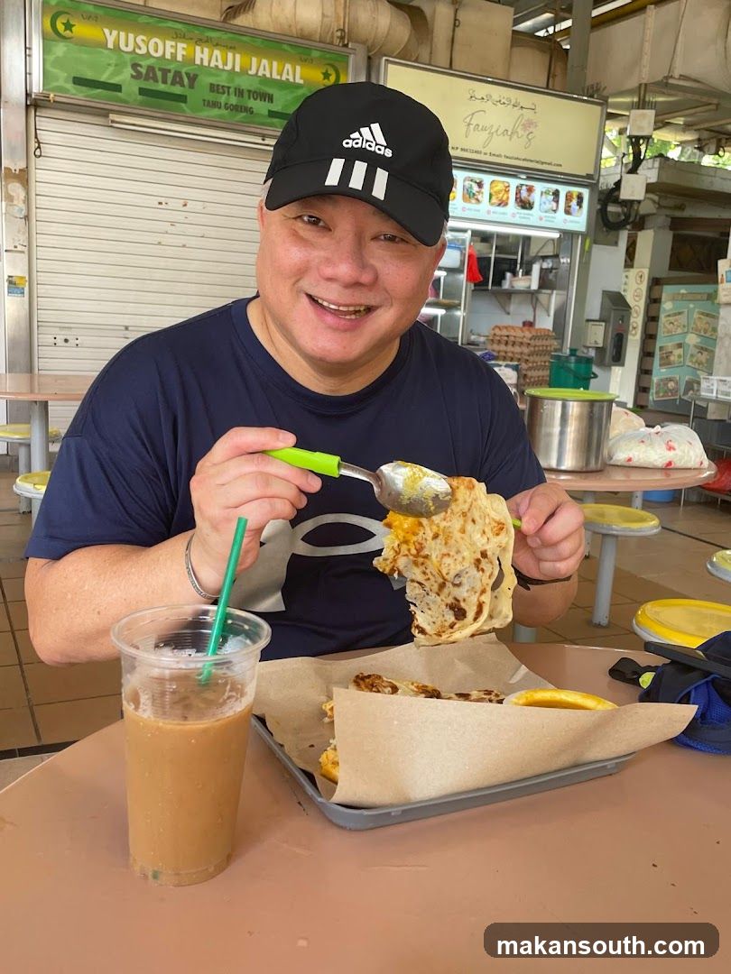 Man eating Roti Prata