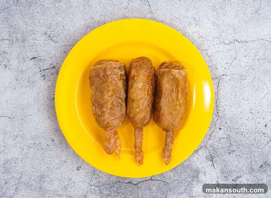 Three Fried Rolls on a Yellow Plate
