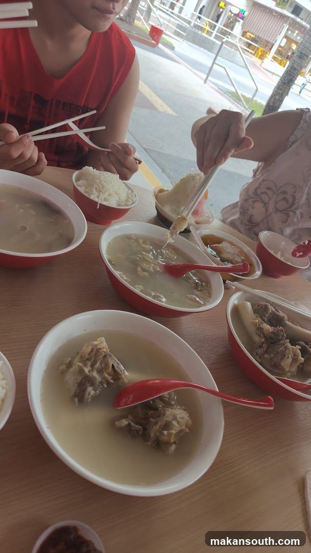 People eating soup and rice