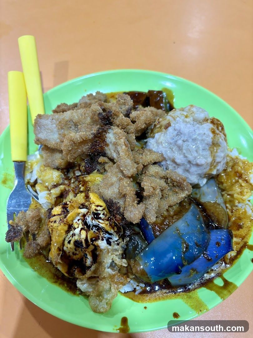 Rice dish with fried pork, egg, and eggplant
