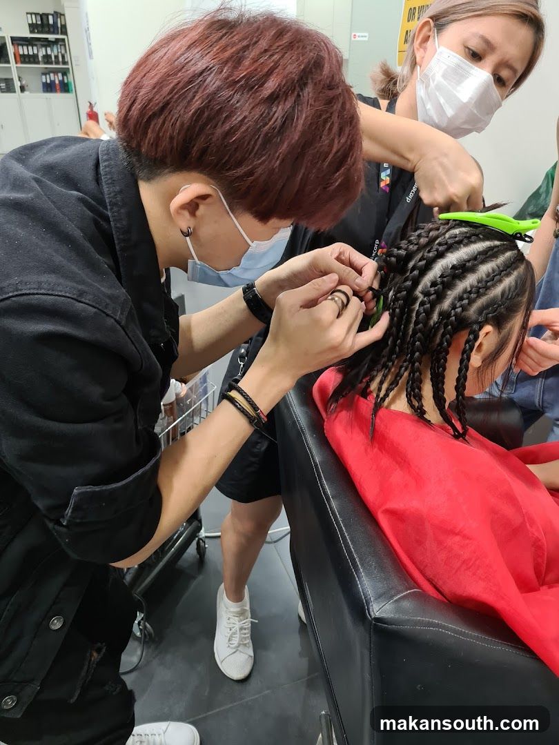 Hairdressers braiding hair